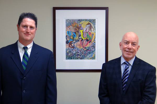 Marc Gordon and Chris Froba standing in front of picture