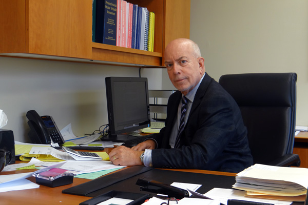 Marc Gordon sitting at office desk