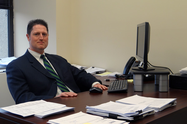 Chris Froba sitting at office desk